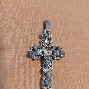 Intricate Silver Cross Pendant with Sparkling Blue Gems